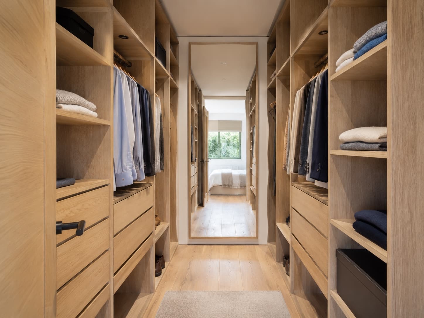 Custom light wood wardrobe in a bright bedroom in Luxembourg