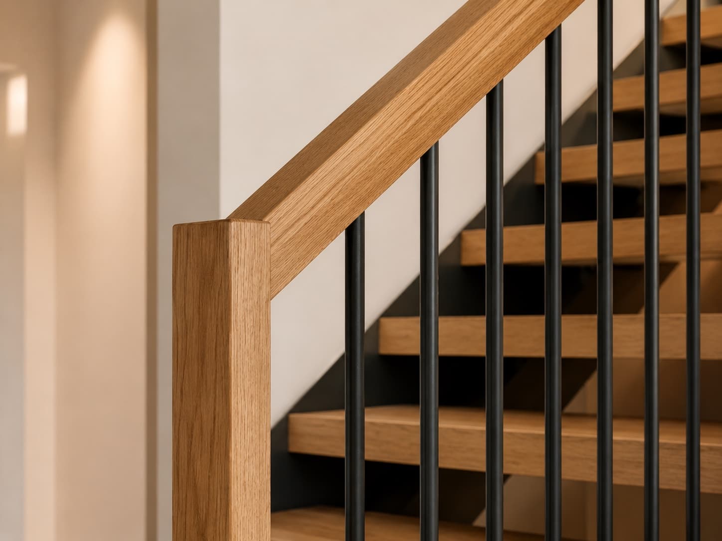 Mixed guardrail with black metal balusters and oak handrail